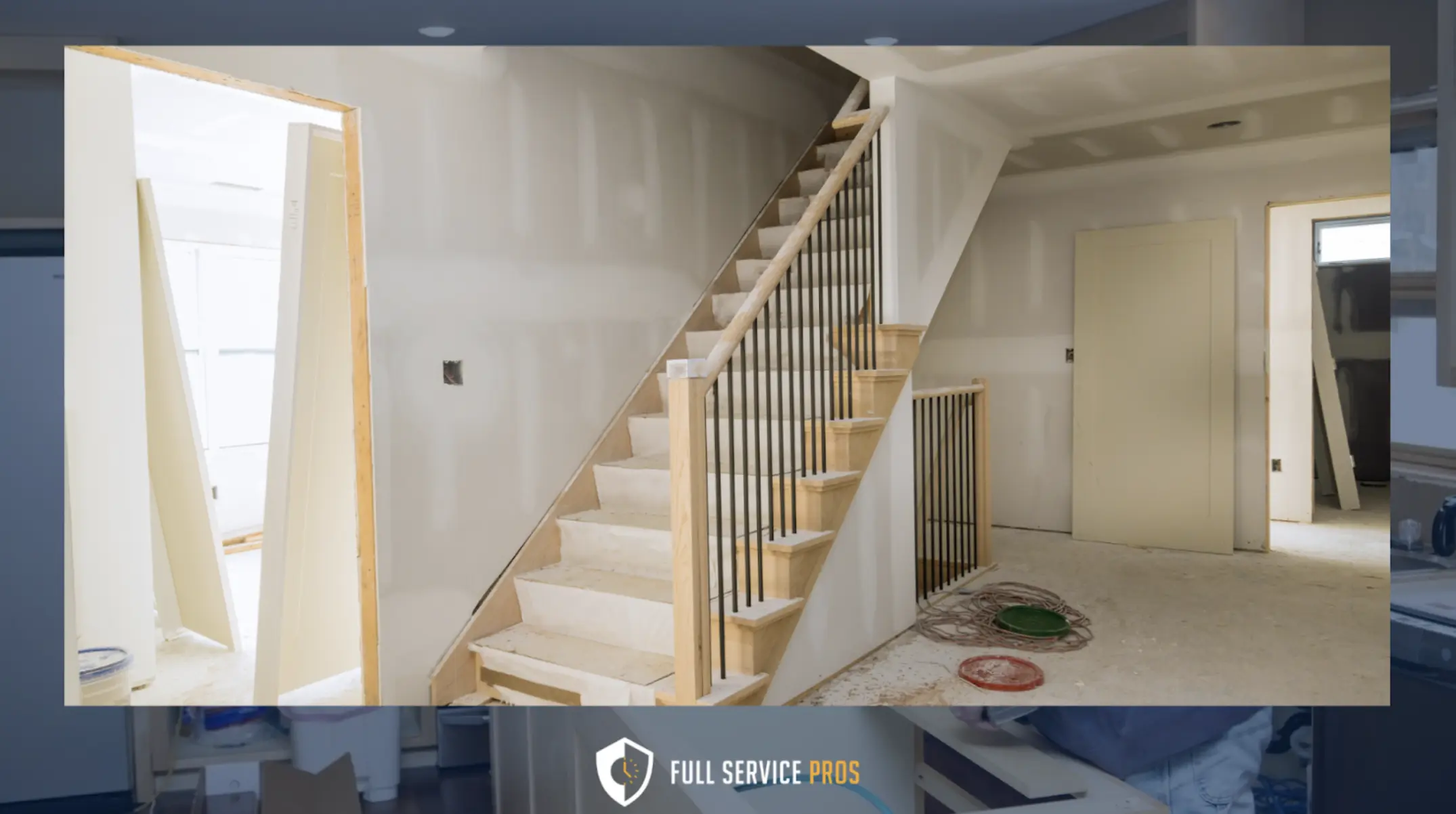 Restoration Services: An unfinished interior with drywall installed, an unpainted staircase with railings, and construction materials scattered on the floor.